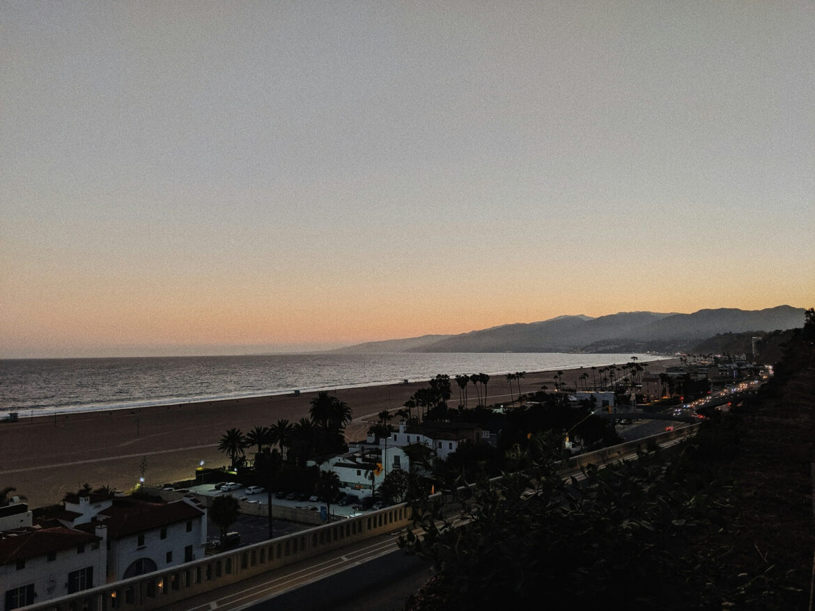 Scenic view of the West Coast shoreline at sunset with waves crashing on the rocks
