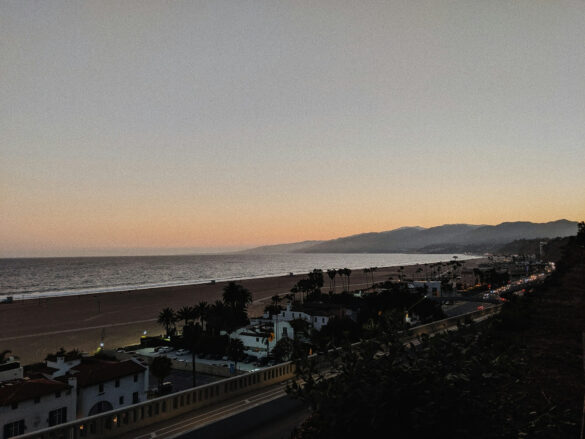 Scenic view of the West Coast shoreline at sunset with waves crashing on the rocks